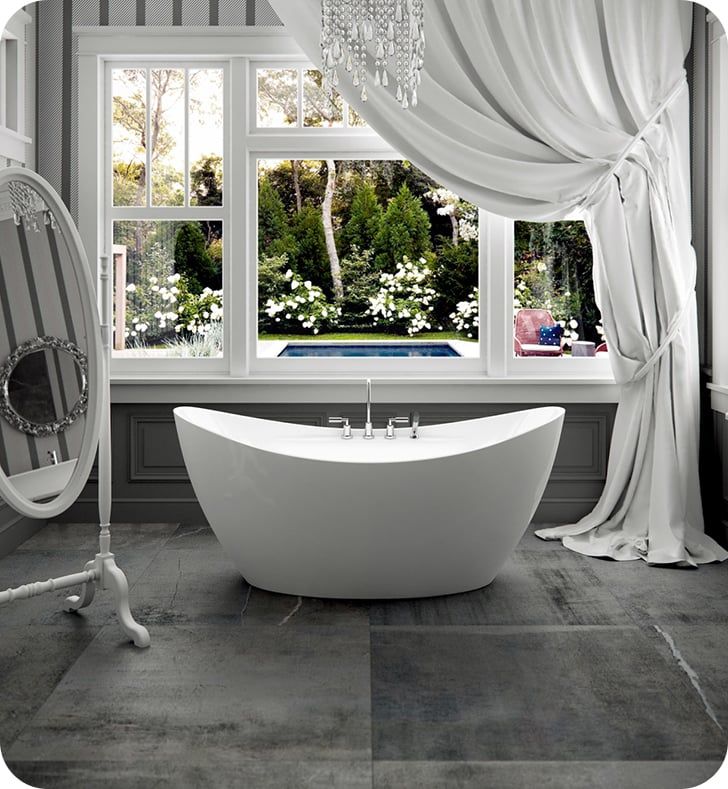 a white bath tub sitting next to a window