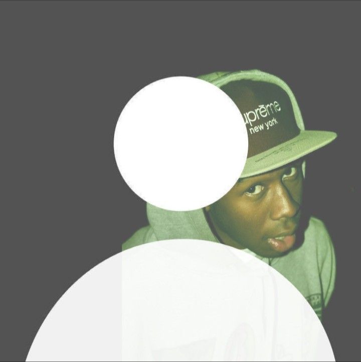 a person wearing a hat with a white circle around it's face in front of a black background