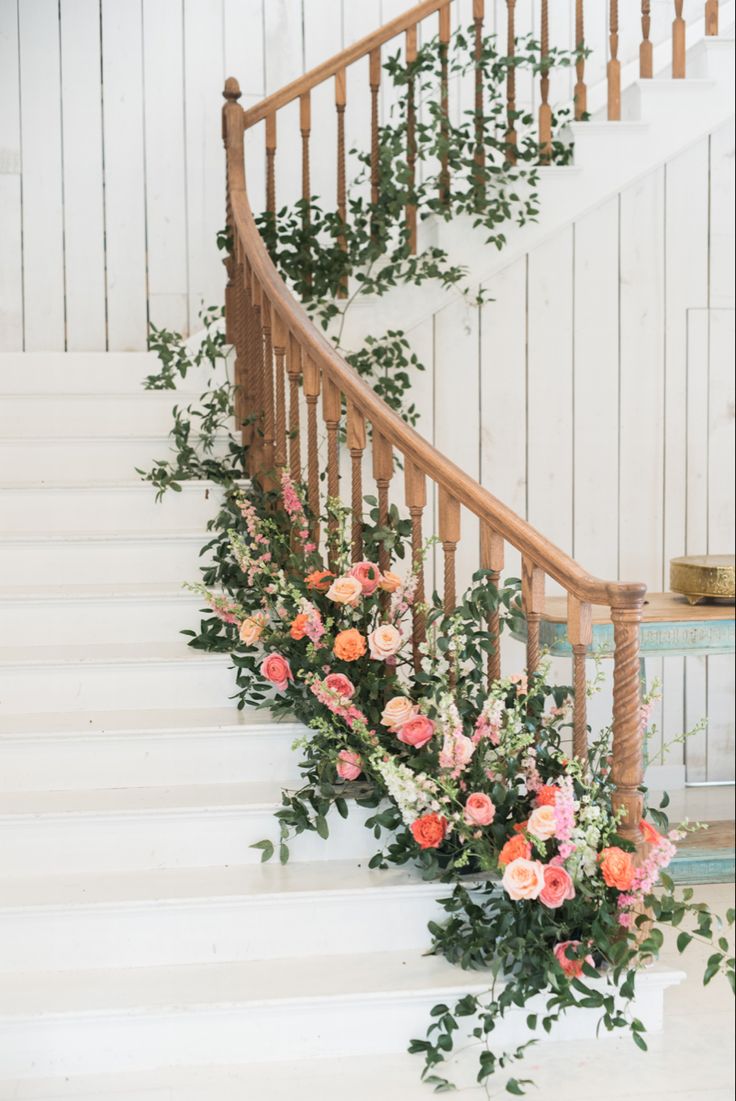 flowers are growing on the bannister and next to it is a set of stairs