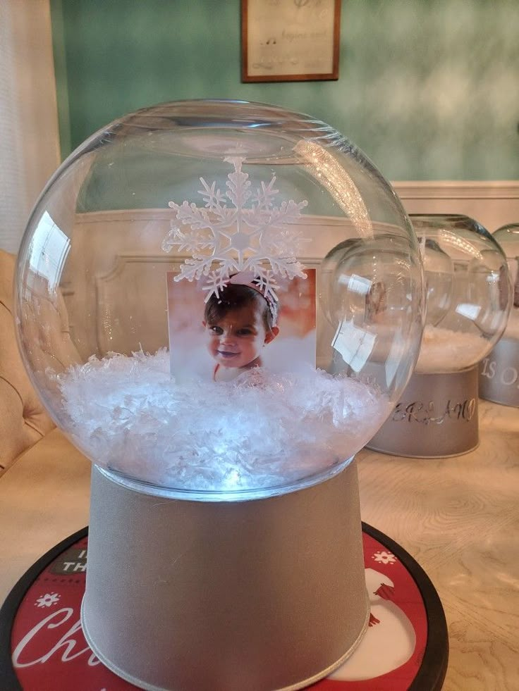 a snow globe with an image of a child in it on top of a table