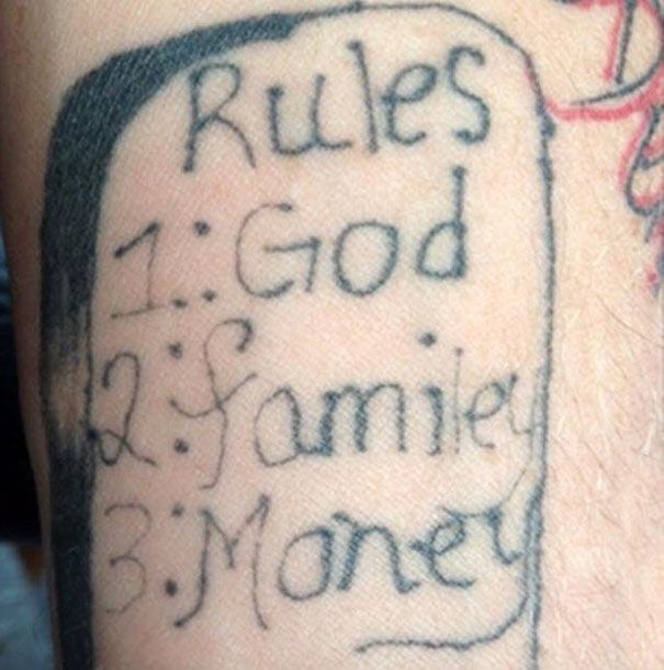 a man's arm with writing on it that says rules god and jamie money