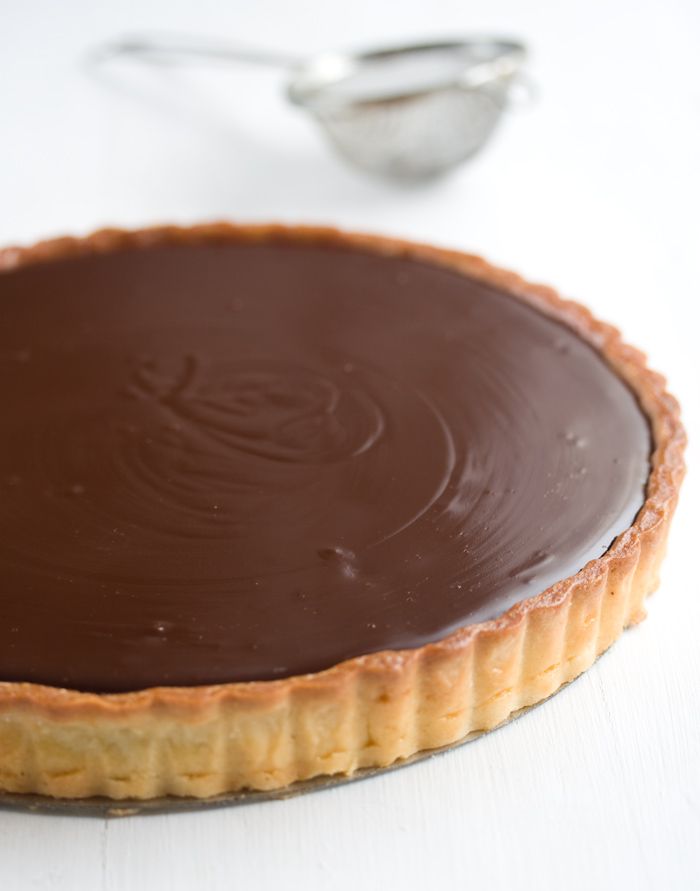 a chocolate tart sitting on top of a white table