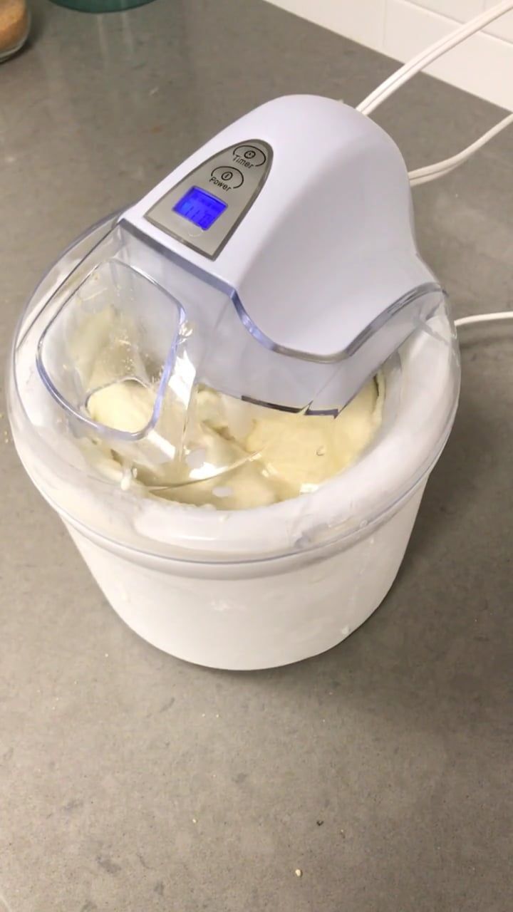 a blender filled with bananas sitting on top of a counter next to a wall