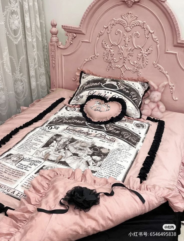 a pink bed with black ruffles and pillows on it's headboard