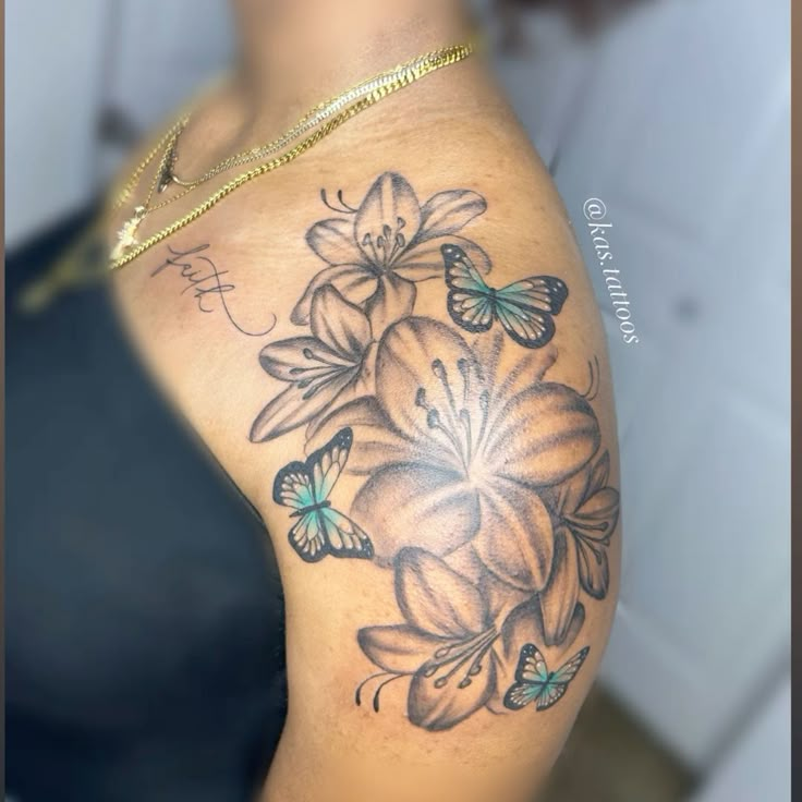 a woman's arm with flowers and butterflies on it