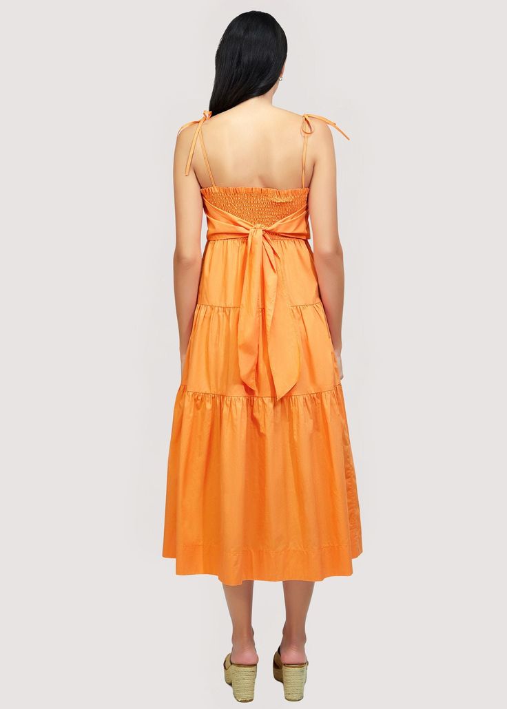 Get ready to turn heads in our Paradiso Midi Dress! Made from soft cotton poplin in a beautiful apricot shade, this dress is a true sun dress silhouette. Its relaxed fit and easy midi length make it the perfect choice for sunny days. Complete your look with sandals and a sun hat. WDWH23282 Imported Lined Self: 100% CottonLining: 100% Rayon Model is 5 ft 9.5 inches; Bust: 32", Waist: 24", Hips: 34" and wearing a size Small Runs true to size Hand wash or wash with gentle cycle with cold water with Solid Cotton Midi Dress For Beach, Cotton Midi Dress For Summer, Solid Midi Sundress For Brunch, Solid Color Cotton Midi Sundress, Solid Cotton Sundress Midi Dress, Solid Color Summer Midi Dress For Daywear, Cotton Midi Sundress For Brunch, Orange Midi Dress For Beach, Orange Cotton Midi Dress For Beach