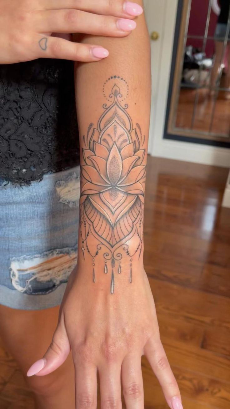 a woman's arm with a tattoo on it and a flower in the middle