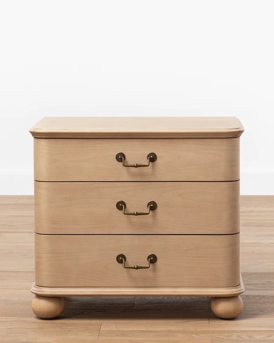 a wooden dresser sitting on top of a hard wood floor