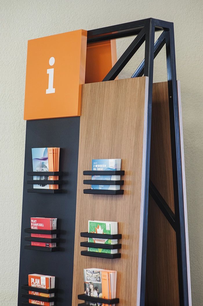 a book shelf with several books on it and an orange sign above the shelves that says i love books