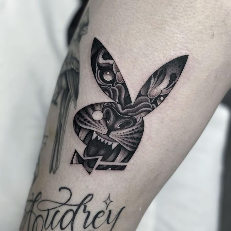 a black and white photo of a rabbit tattoo