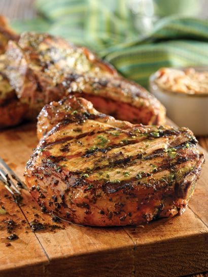 grilled steaks on a cutting board with a fork