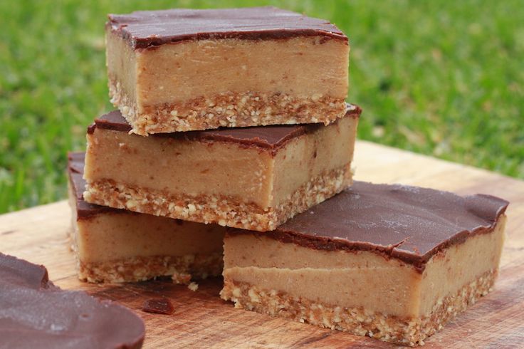 four pieces of chocolate peanut butter bars stacked on top of each other