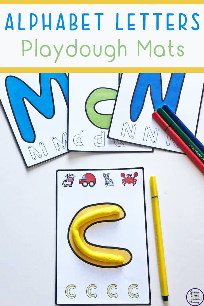 alphabet letters playdough mats with crayons and pencils on the table