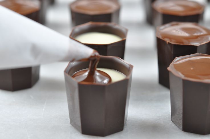 chocolate cups are lined up and ready to be filled with melted chocolates or pudding