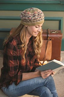 a woman sitting on the ground reading a book