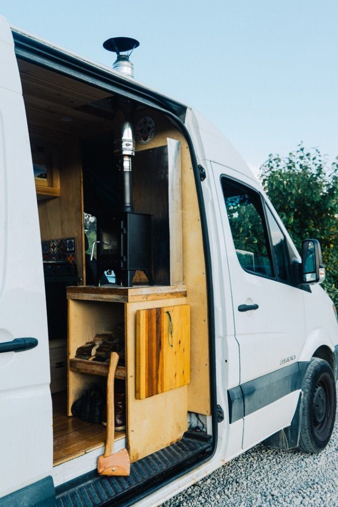 the back door of a white van is open and there are various items in it