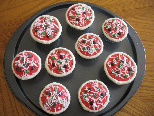 twelve decorated cookies sitting on top of a black plate