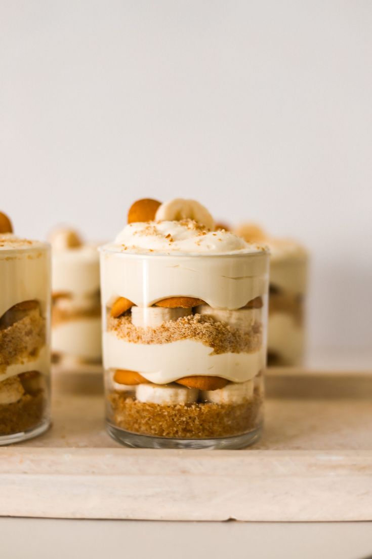 small desserts in glass containers sitting on a table