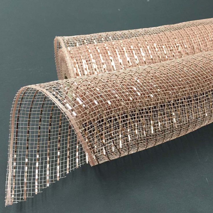 a roll of wire mesh on top of a black surface