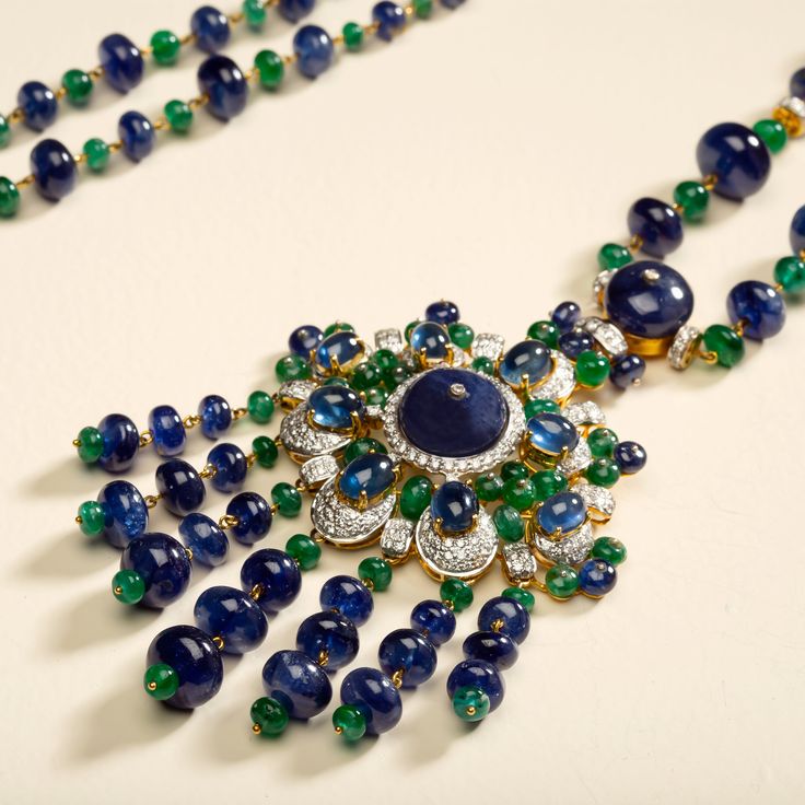 18 karat gold necklace with diamond, emerald and sapphire by fine jewelry designer ESTAA. “The Peacock Necklace” is a unique wearable art piece, weaving Indian tradition with contemporary design. Sapphire is said to be a stone of royalty bringing protection, power and strength. Whilst emerald has been known as a symbol of truth and love. 18 karat Gold 7.78 carats of diamonds brillant cut 7.61 carats of Emeralds 548.89 carats of Blue Sapphires Weight: 190g Width: 75 in. (19cm)Depth: 12 in. (30.5c Elegant Sapphire Multi-stone Necklace, Luxury Jeweled Pendant Jewelry, Elegant Blue Emerald Necklaces, Luxury Green Sapphire Jewelry, Luxury Sapphire Necklace With Gemstone Accents, Luxury Diamond Jeweled Necklaces, Luxury Diamond Jeweled Necklace, Luxury Jeweled Emerald Jewelry, Luxury Emerald Necklace With Gemstone Accents