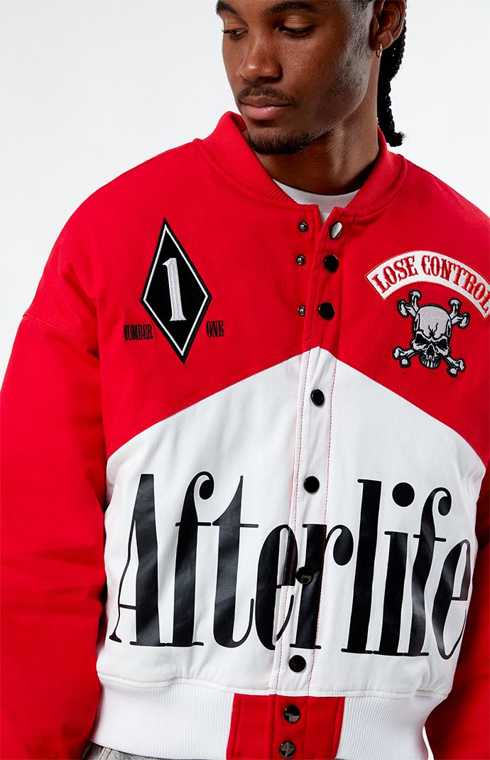 Step into the fast lane with the PacSun Afterlife Race Jacket, designed to elevate your streetwear game. This jacket boasts a sleek and sporty design, perfect for those who appreciate the thrill of speed and style. With its lightweight construction and bold graphics, it's sure to turn heads wherever you go.


	Ribbed collar
	Long sleeves
	Button closures
	Ribbed cuffs & hem
	Left chest patch
	Large front graphic
	Quilted lining
	Body: 97% cotton, 3% spandex
	Machine washable
	Model is wearing size medium
	Model Measurements: 6'1” Height, 31” Waist, 32” Inseam Sporty College Track Jacket With Graphic Print, Varsity Crew Neck Sports Outerwear, Graphic Print Baseball Collar Outerwear For Streetwear, Graphic Print Outerwear With Baseball Collar For Streetwear, Red Sports Event Outerwear With Baseball Collar, Red Baseball Collar Outerwear For Sports Events, Sporty Crew Neck Outerwear With Letter Print, Sporty Long Sleeve Varsity Jacket For Streetwear, Cotton Outerwear With Graphic Print For Sports Events