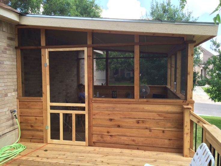 a small wooden porch with sliding glass doors