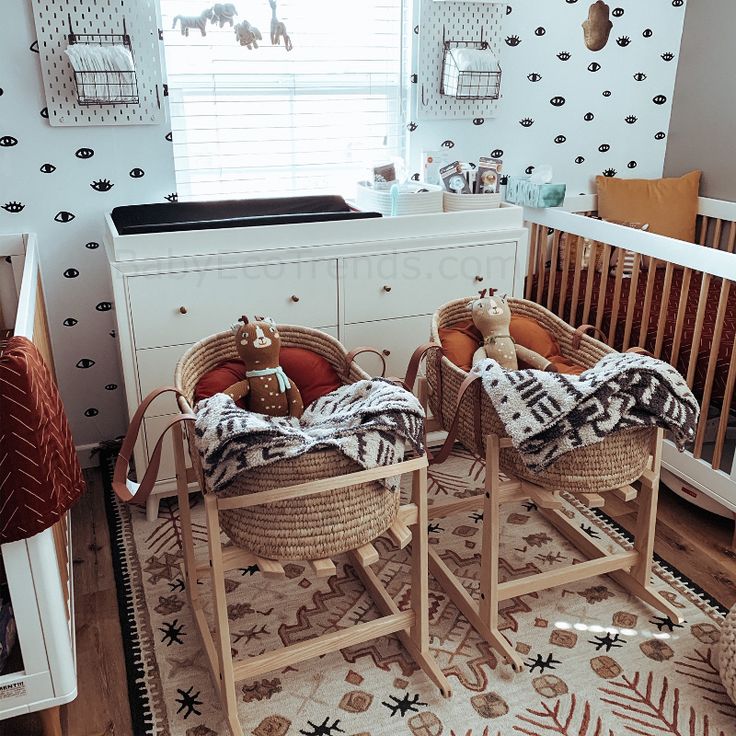 two baby cribs with blankets on them in a child's room