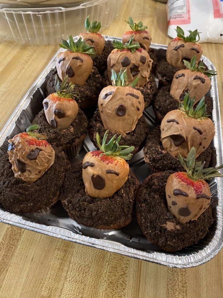 chocolate cupcakes decorated with strawberries and chocolate frosting in the shape of teddy bears