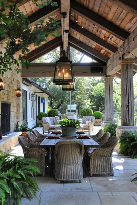 an outdoor dining area with wicker chairs and table surrounded by greenery on the patio