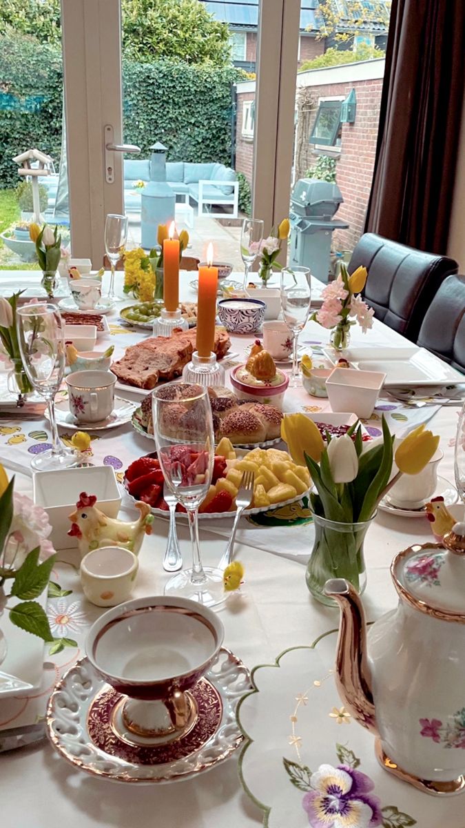 a table set with dishes, cups and saucers