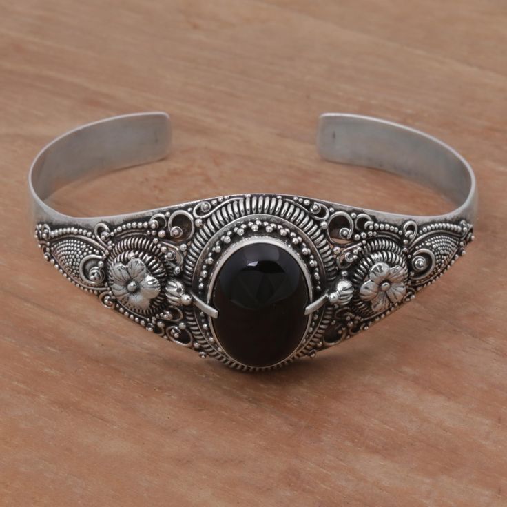 Featuring exquisite floral patterns, this dazzling cuff bracelet reflects the tropical beauty of Bali's Sindu beach. An oval of black onyx rests at the center of the ornate front panel, adding a sophisticated vibe to the bracelet's cuff design by Komang Suastra. Sterling silver, dyed onyx Combination finish Handmade in & fairly traded from Indonesia Cheap Silver Rings, Floral Cuff, Tropical Beauty, Metal Cuff Bracelet, Gold And Silver Bracelets, Silver Rings With Stones, Black Onyx Necklace, Earrings Hoops, Floral Bracelet