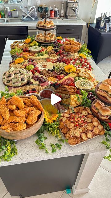 a table filled with lots of food on top of a kitchen counter