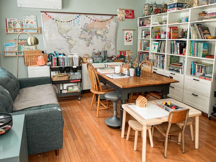 a living room filled with furniture and bookshelves next to a dining room table