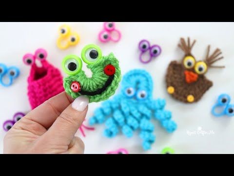 someone is holding up some crocheted items to make them look like they are smiling