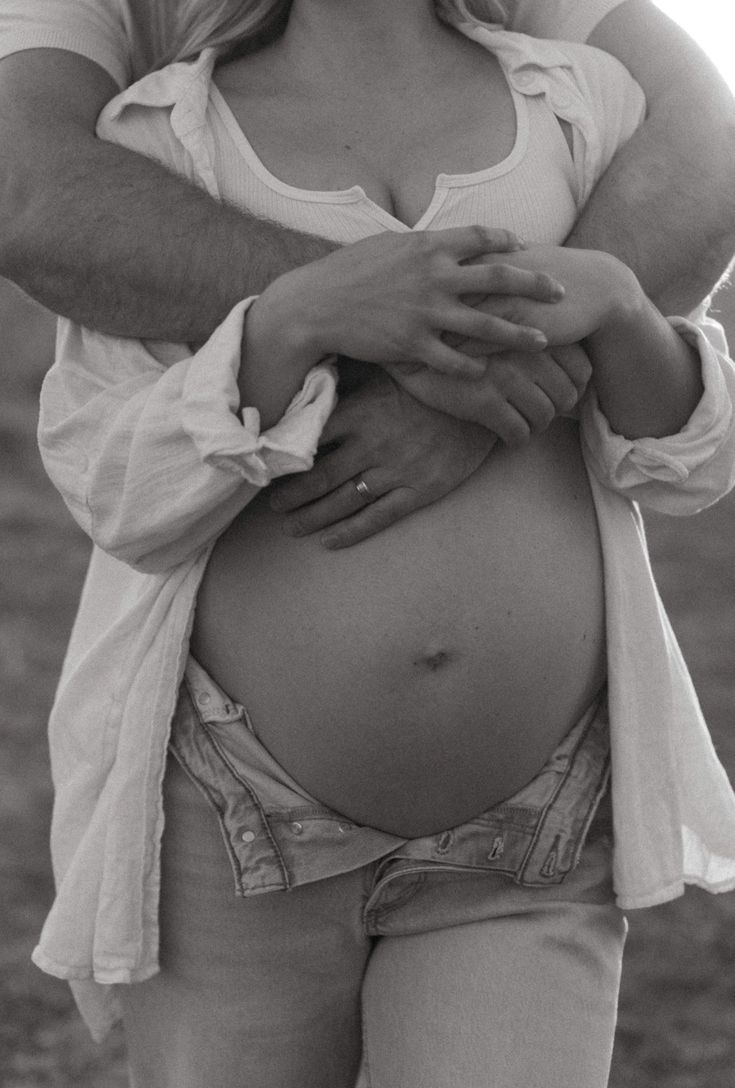 a pregnant woman is holding her husband's belly