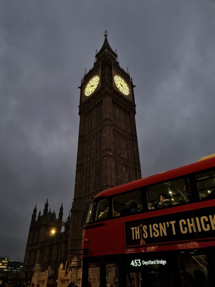 the big ben clock tower towering over the city of london, england at night time