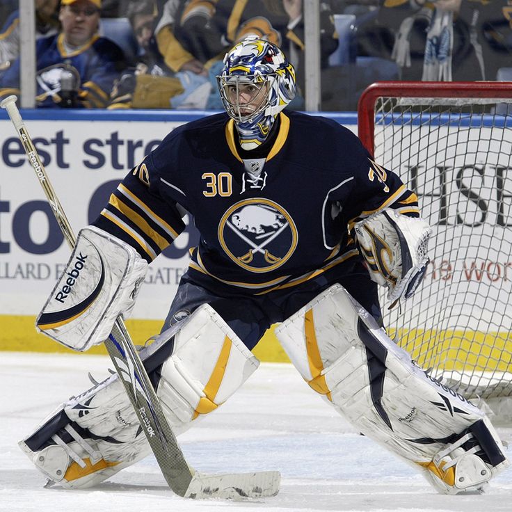 a hockey goalie is waiting for the puck