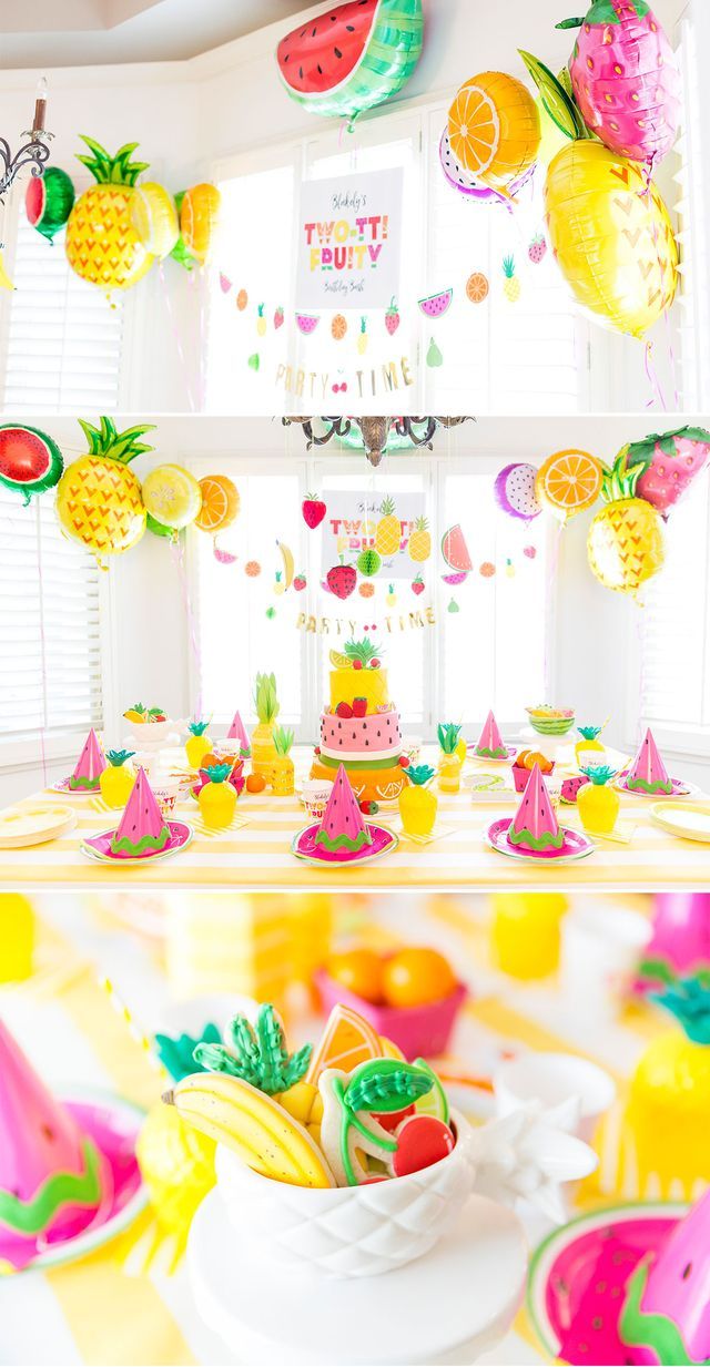 there is a table set up for a party with pineapples and watermelon