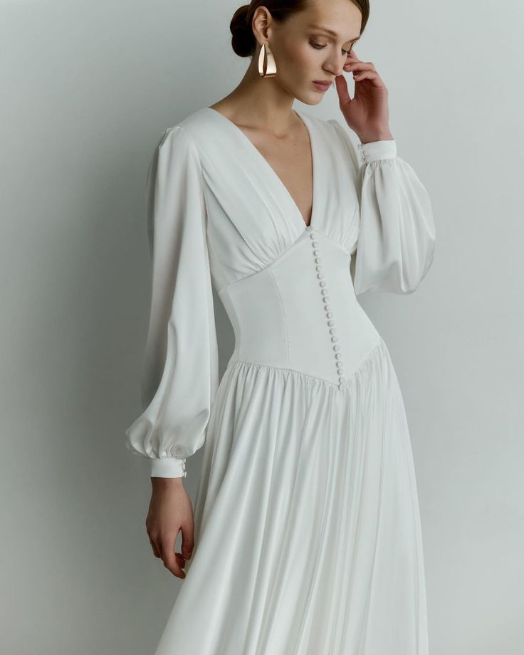 Reev Bridal | Ellery | Satin gown that subtly combines vintage-inspired low-waist bodice with mesmerizing long train skirt More gowns on ReevBridal.com | Instagram Long Shirt Wedding Dress, Waisted Wedding Dress, Aline Sleeve Wedding Dress, Minimal Vintage Wedding Dress, Long Sleeve Wedding Dress Silk Satin, Long Sleeve Wedding Dress Casual, Long Sleeved V Neck Wedding Dress, Simple Flowy Wedding Dress Sleeve, Fall Wedding Dress With Sleeves