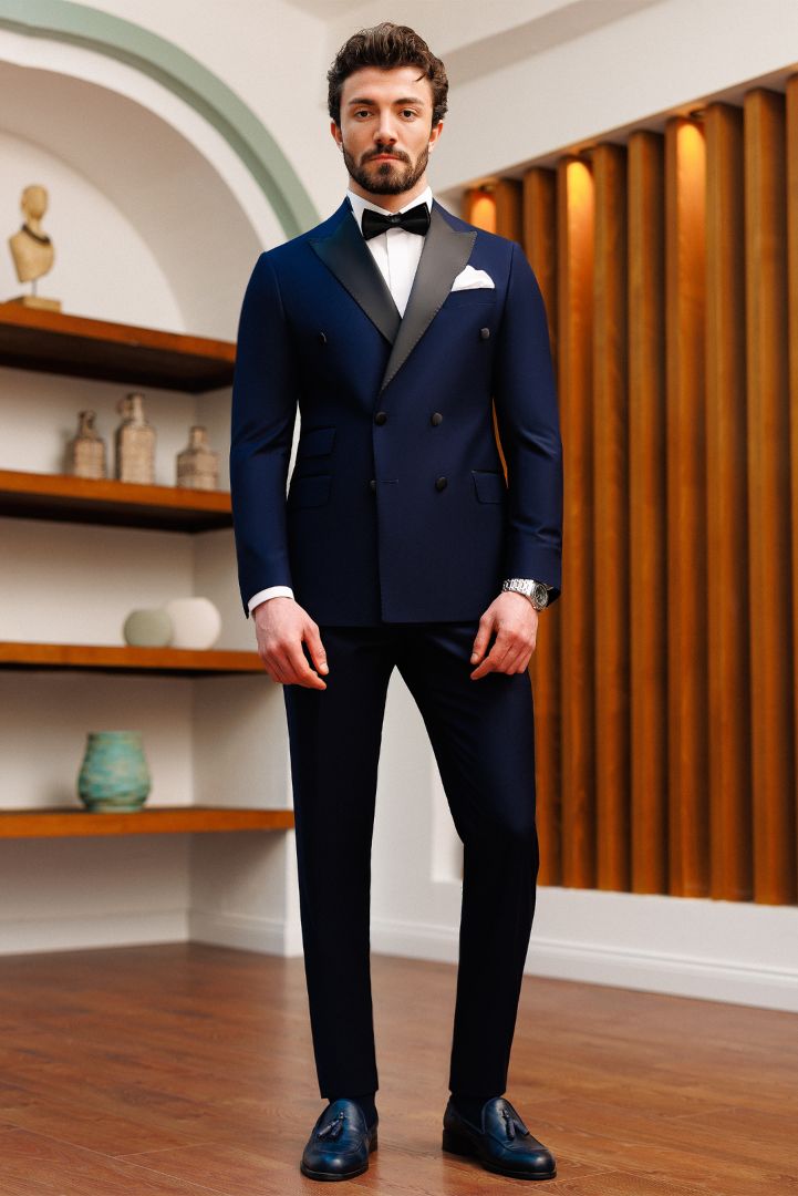 Take charge of the spotlight with our Navy Double-Breasted Tuxedo 2-Piece. The double-breasted 6-button blazer, adorned with peak lapels, paired with trousers, creates a look of timeless elegance and grandeur. Make a grand entrance at any formal affair with this exquisite tuxedo.  #navytuxedo #doublebreastedtuxedo #formalwear #tuxedo #mensfashion #specialoccasion #sophisticatedlook #formalattire #dapper Male Wedding Suit, Men's Tuxedo Styles, 3 Piece Suit Men, Wedding Suits Men Black, Suit For Men Wedding, Formal Suits Men, Indian Wedding Clothes For Men, Wedding Kurta For Men, Stylish Mens Suits