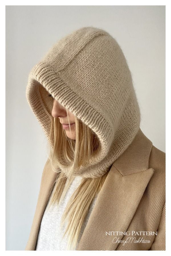 a woman with blonde hair wearing a beige hoodie