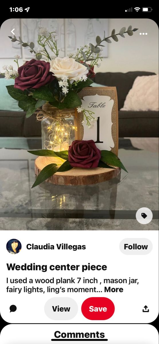 a vase with flowers on top of a table next to a sign that says wedding center piece