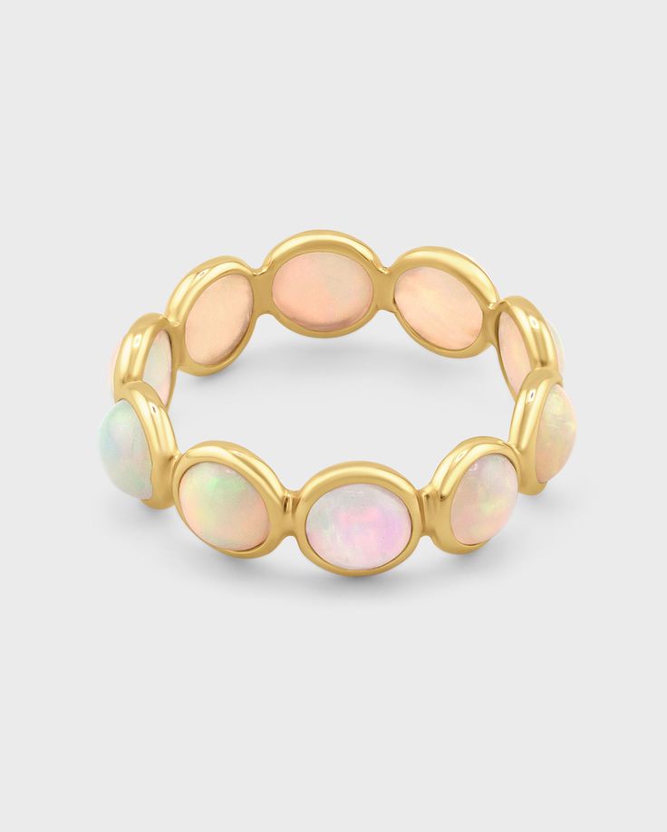 This handcrafted ring showcases a delicate circle of luminous opals set in 14k gold, handmade with care in NYC. Each opal stone exhibits subtle variations in color, creating a shimmering, iridescent effect that captures the beauty of natural opals. The elegant design offers a modern take on classic opal jewelry, perfect for everyday wear or special occasions. Opal 14 Karat Gold Size 5,6,7,8,9 Handmade in NYC Yellow Gold Opal Ring With Round Gemstone, Yellow Gold Round Opal Jewelry, Yellow Gold Opal Jewelry In Round Shape, Elegant Adjustable Opal Stackable Rings, Elegant Pink Opal Moonstone Ring, Gold Opal Stackable Ring, Gold Stackable Opal Ring, Yellow Gold Cabochon Opal Ring, Fine Jewelry Stackable Opal Ring With Round Band