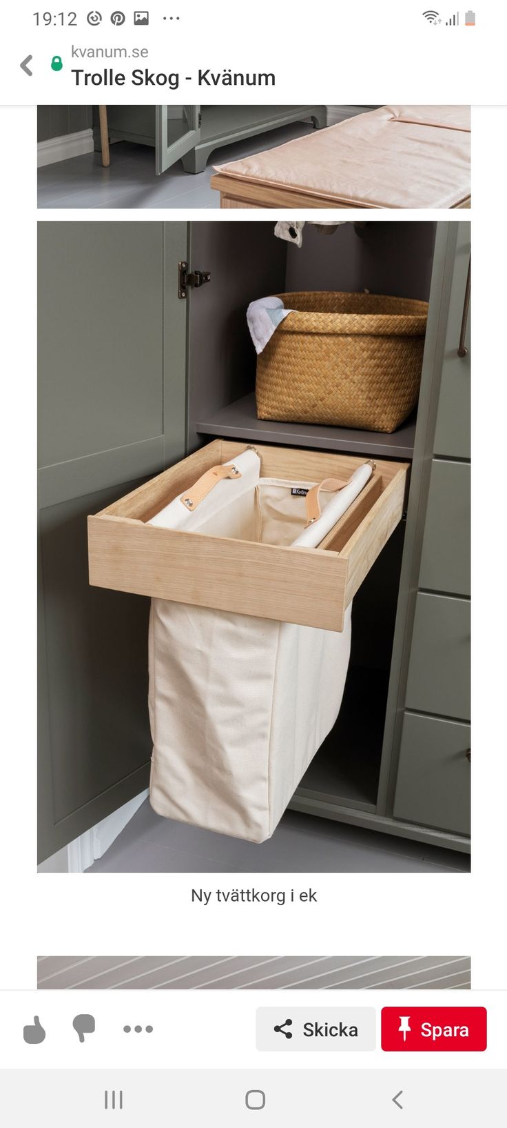 an open cabinet with a basket and clothes hanging on the door, next to it is a laundry hamper