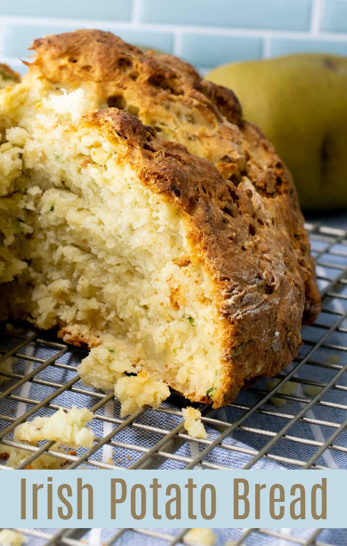 a loaf of irish potato bread sitting on top of a cooling rack next to an apple