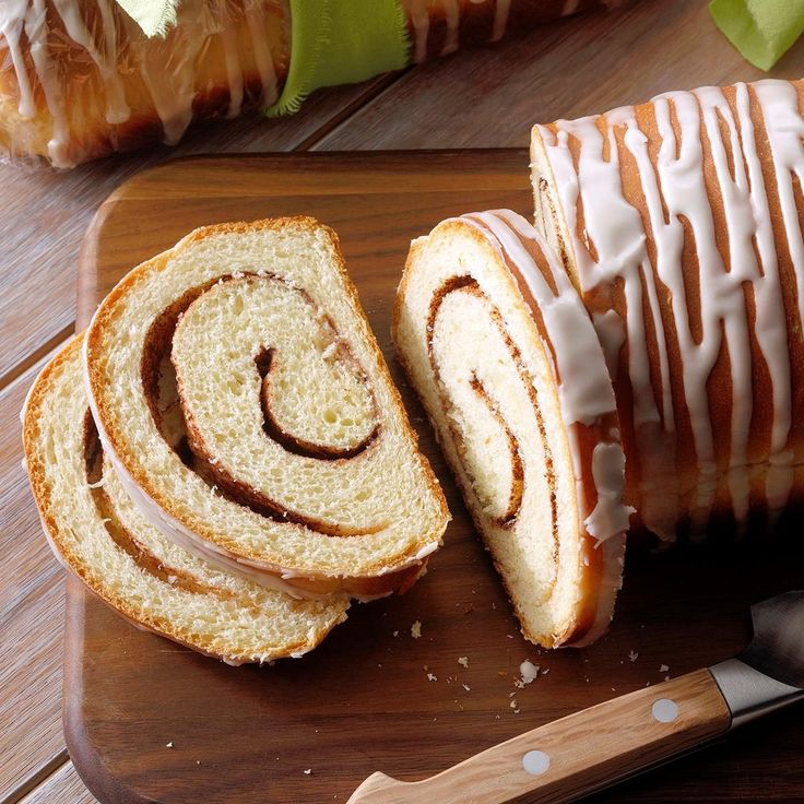 sliced cinnamon swirl bread on a cutting board with knife and apple in the back ground