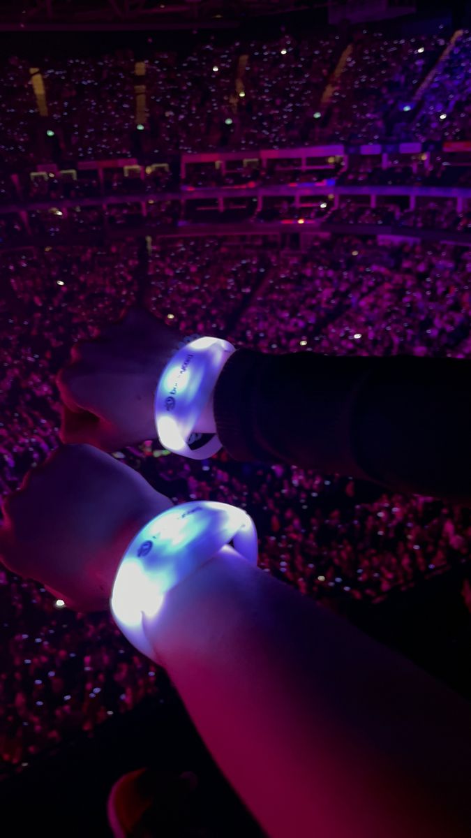 an audience at a concert with bright lights