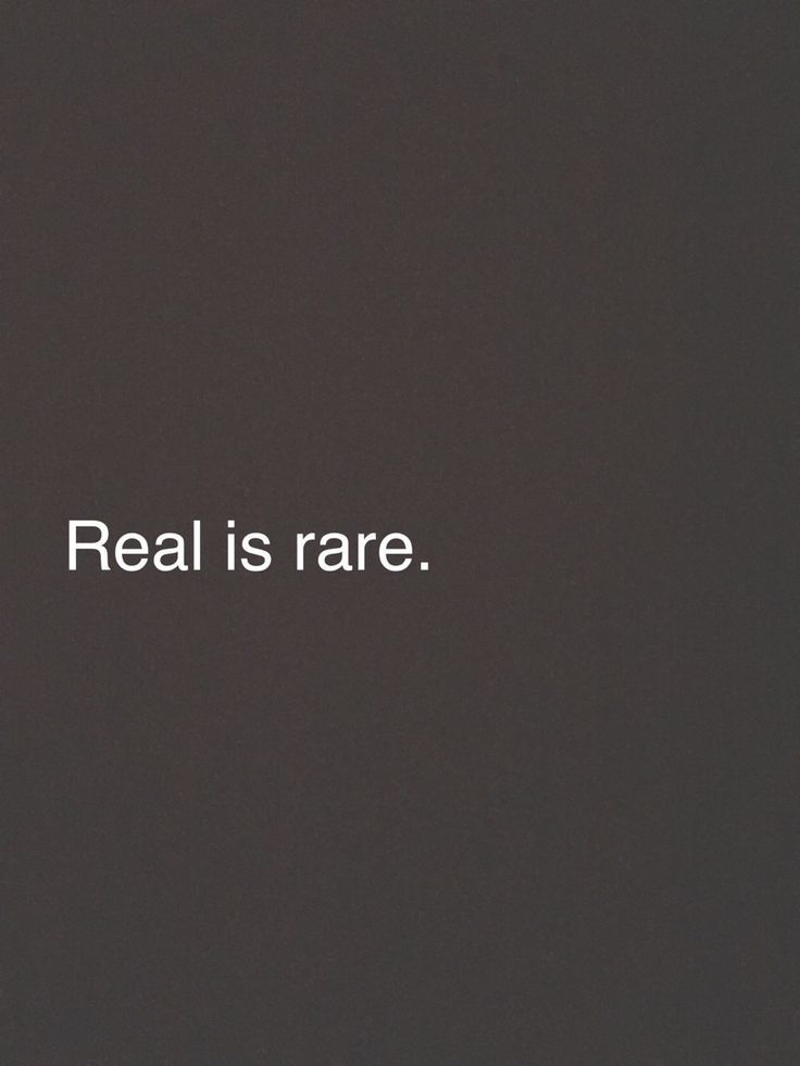 the words real is rare written in white on a black background