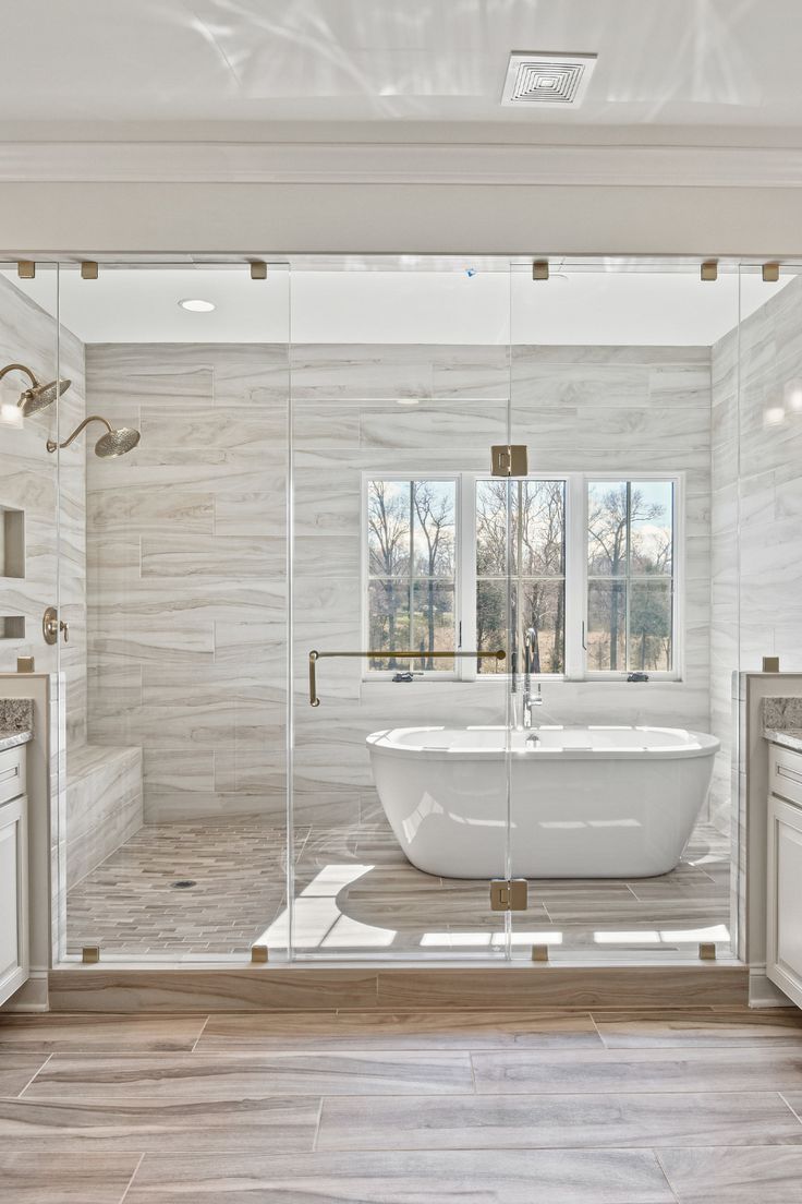 a large white bath tub sitting inside of a bathroom next to a walk in shower