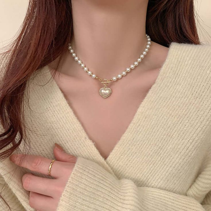 ✦ A must-have accessory for any fashionista, the Mermaid Pearl Beaded hEART cHARM Necklace is sure to add some sparkle and sophistication to your look. With its dainty and special design, this stunning piece will make a statement wherever you go. Get ready to turn heads and make hearts skip a beat when you wear this beautiful necklace! Luxurious, elegant, and timeless! ----------- DESCRIPTIONS ------------ Size (Length): 39.5cm- Color: White, Gold- Materials: Alloy, Mermaid Pearl, Rhinestone- SK Valentine's Day Party Pearl Necklace, White Pearl Chain Heart Necklace, Party Beaded Necklaces With Heart Beads, Elegant Gold Beaded Necklaces For Valentine's Day, Heart Necklace With Pearl Chain For Gift, Elegant Heart Charm Choker Necklace, Heart-shaped Pearl Necklace For Party, Dainty Beaded Necklaces For Wedding, Elegant Heart Choker Necklace For Valentine's Day